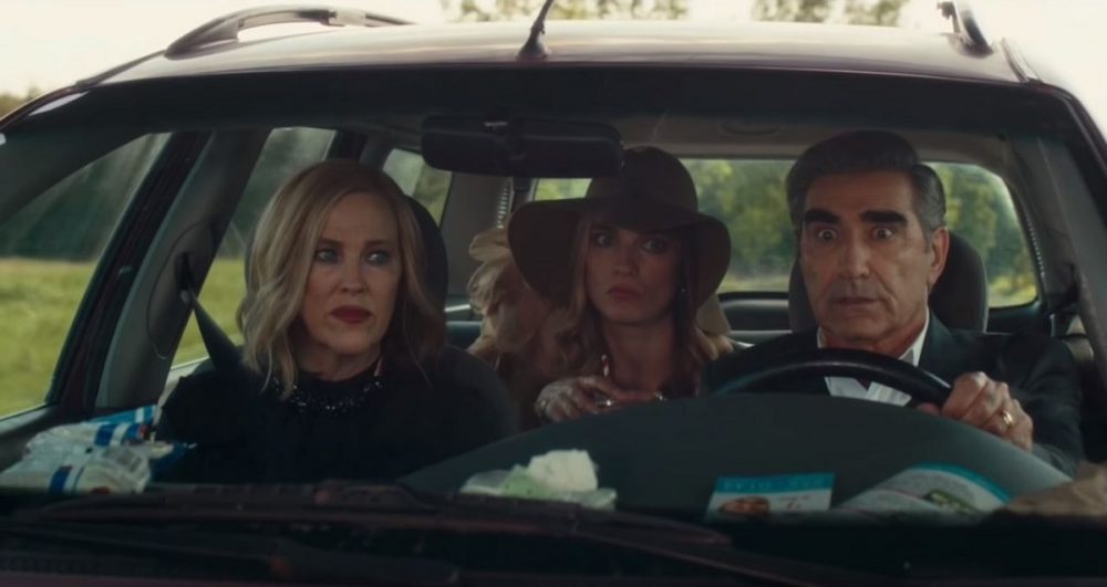 The Rose family Schitt's Creek in a car