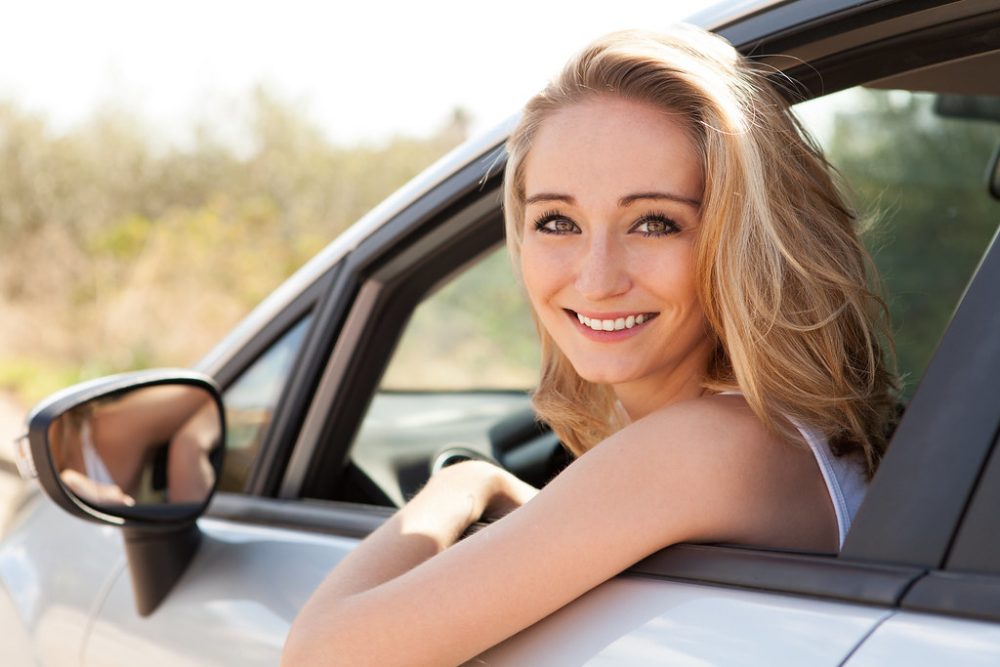 Young teen driver behind the wheel of safe new car