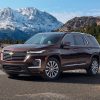 The 2021 Chevrolet Traverse Premier driving with a mountain in the background