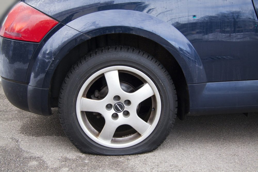 flat tire on a blue car