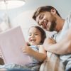 family reading book parent child together