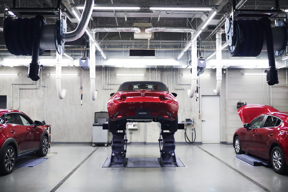 Mazda garage with a Miata up on lifts