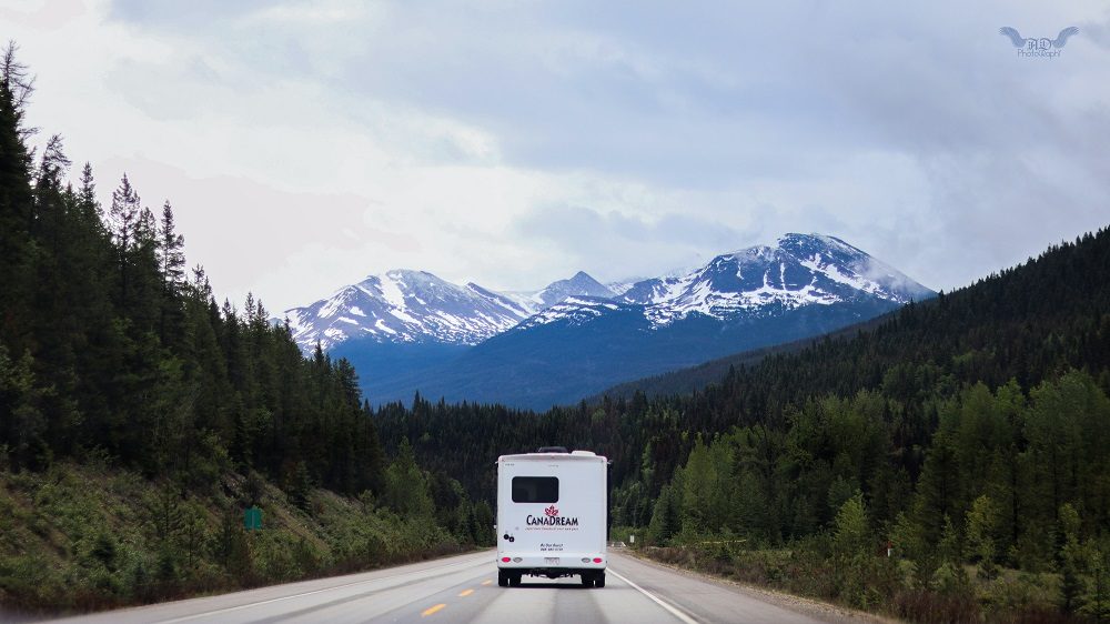 RV Driving Toward Mountains