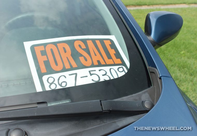 A "for sale" sign in a car window