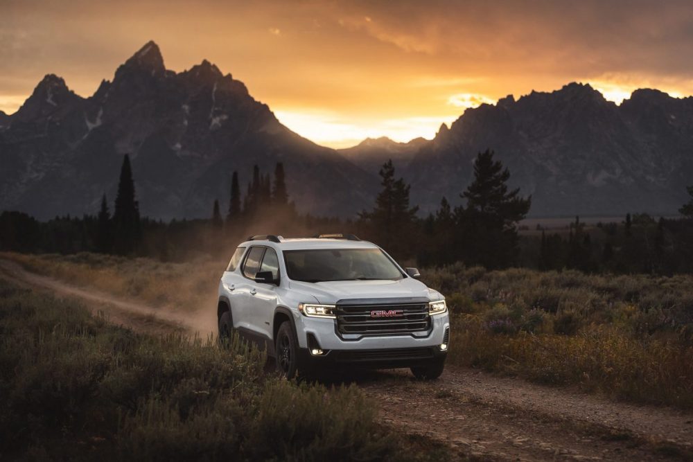 2020 Acadia AT4 driving off-road by a mountain range