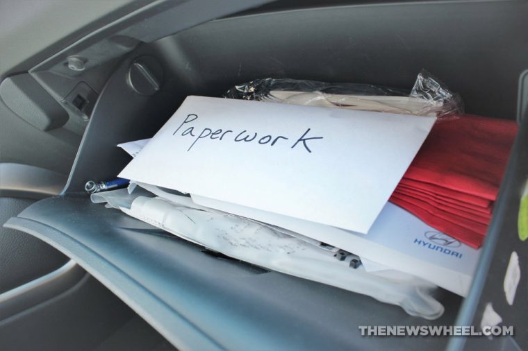 organized glove box with paperwork envelope on top
