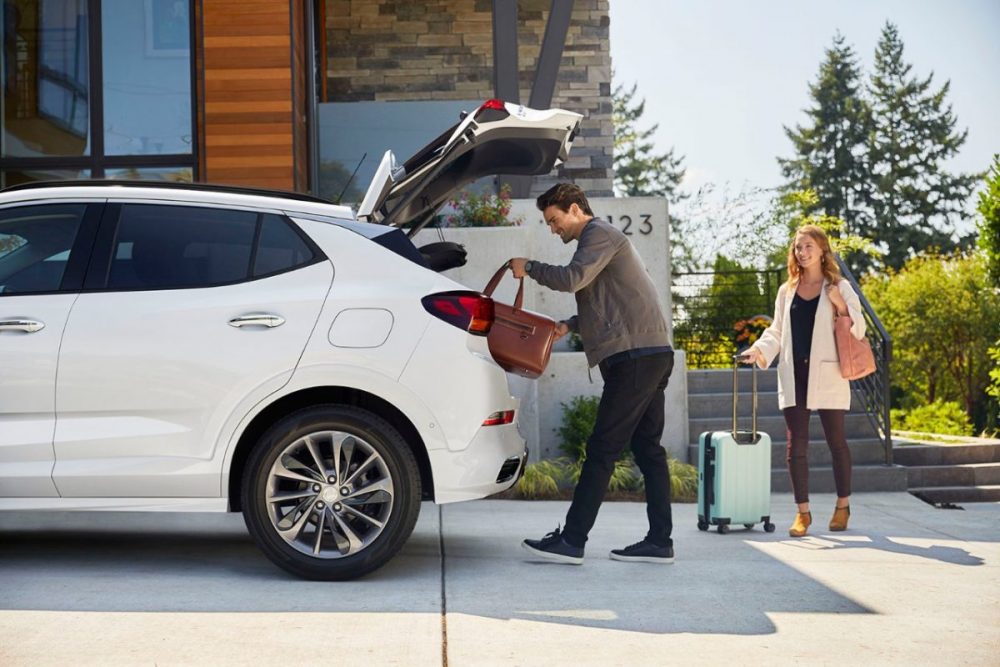 People loading cargo into the back of the 2020 Buick Encore GX