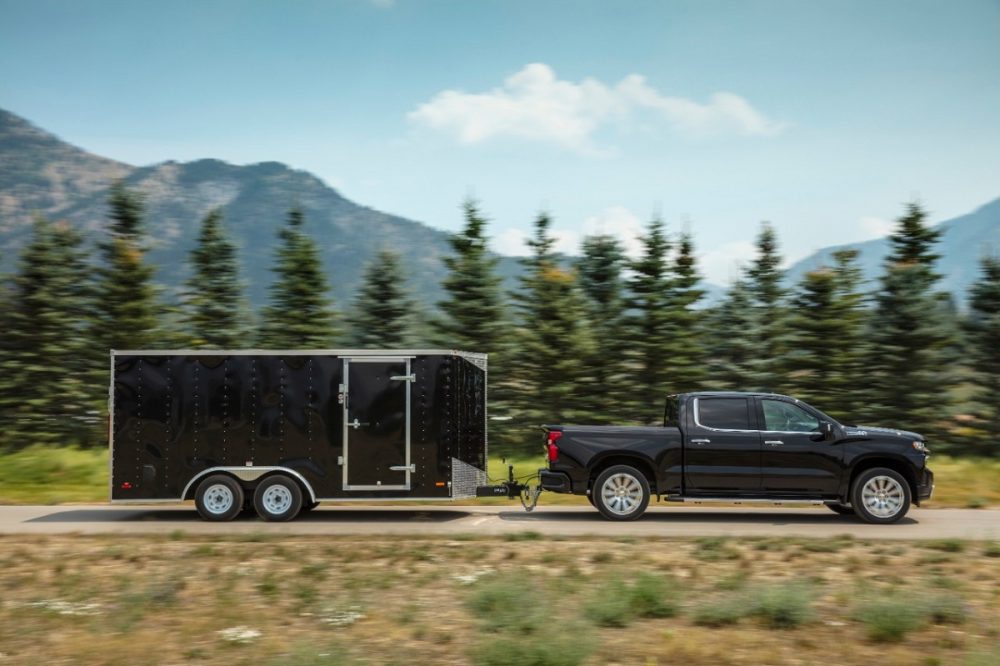 The 2021 Chevrolet Silverado 1500 towing a trailer on the road