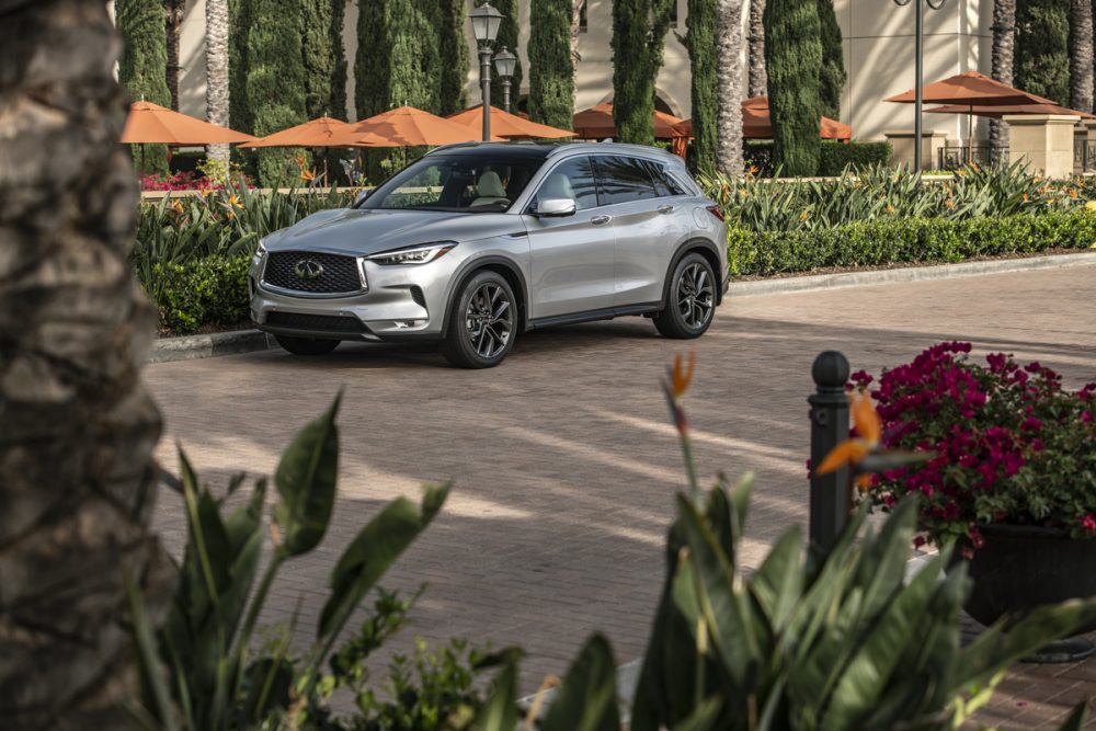 2021 INFINITI QX50 parked in front of an outdoor dining area