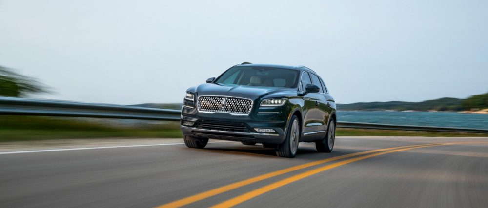 2021 Lincoln Nautilus in Flight Blue driving along a seaside road