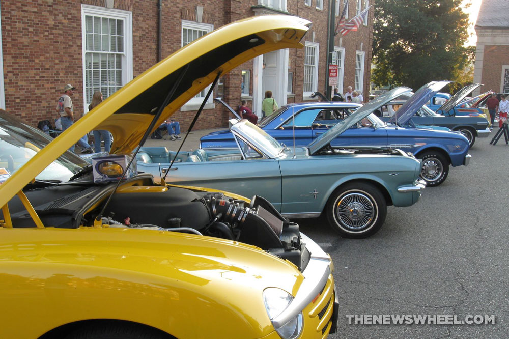 Classic cars show meet with hoods open on display
