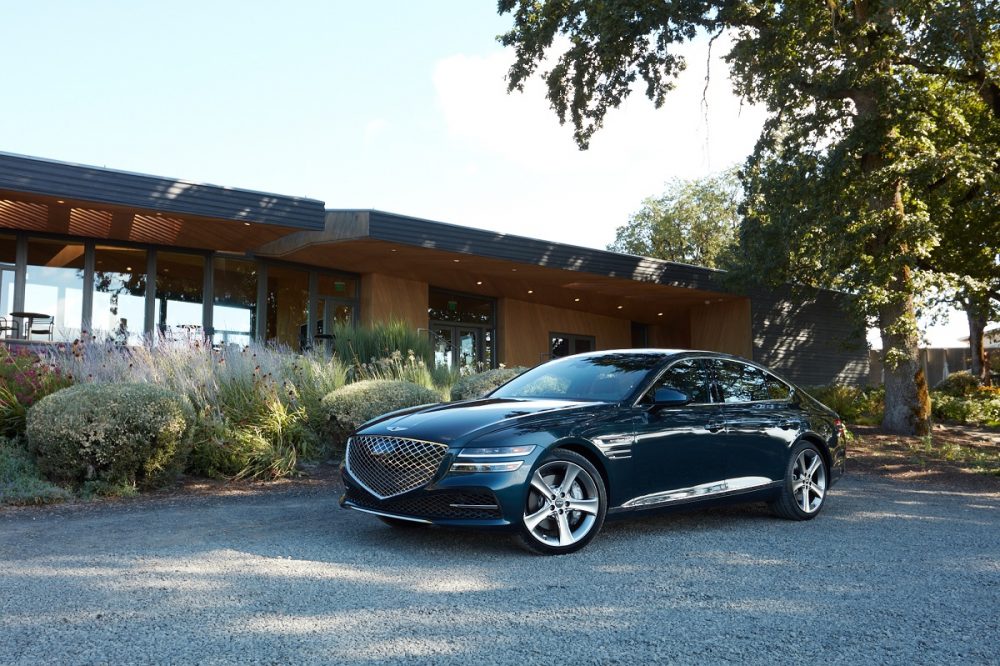 Front side view of 2021 Genesis G80 parked in front of house