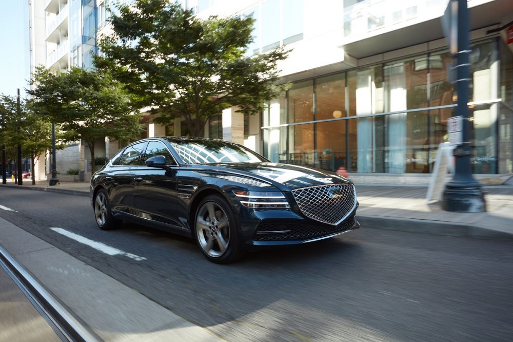 2021 Genesis G80 driving down a city street