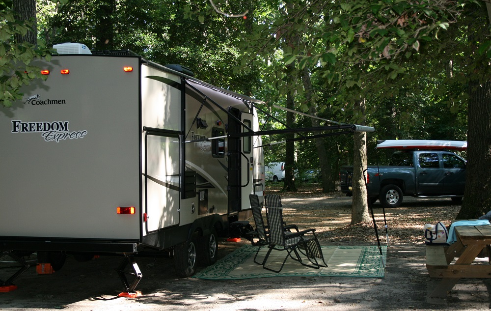 RV popularity is booming - Travel Trailer in a woody campground