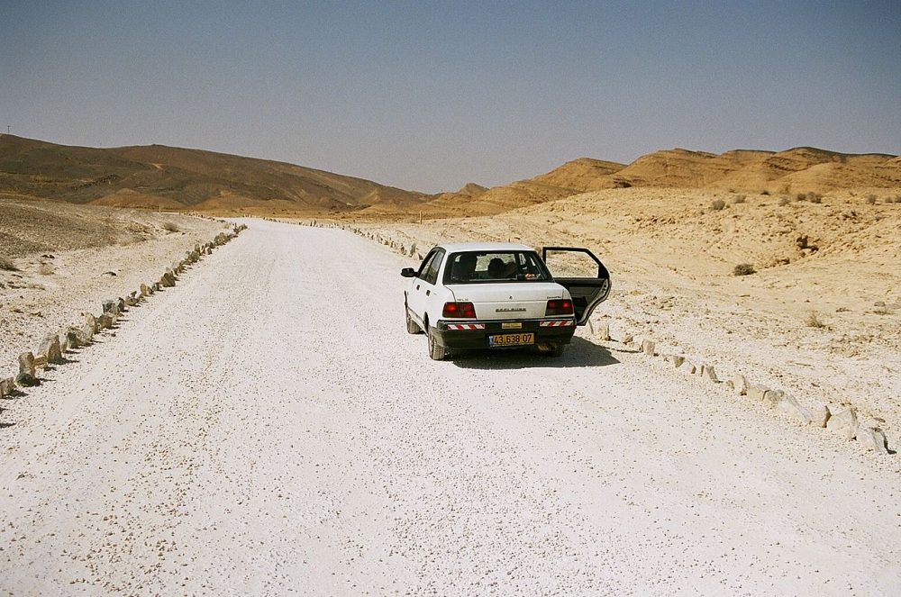 A car looking rather lost in a desert