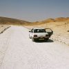 A car looking rather lost in a desert