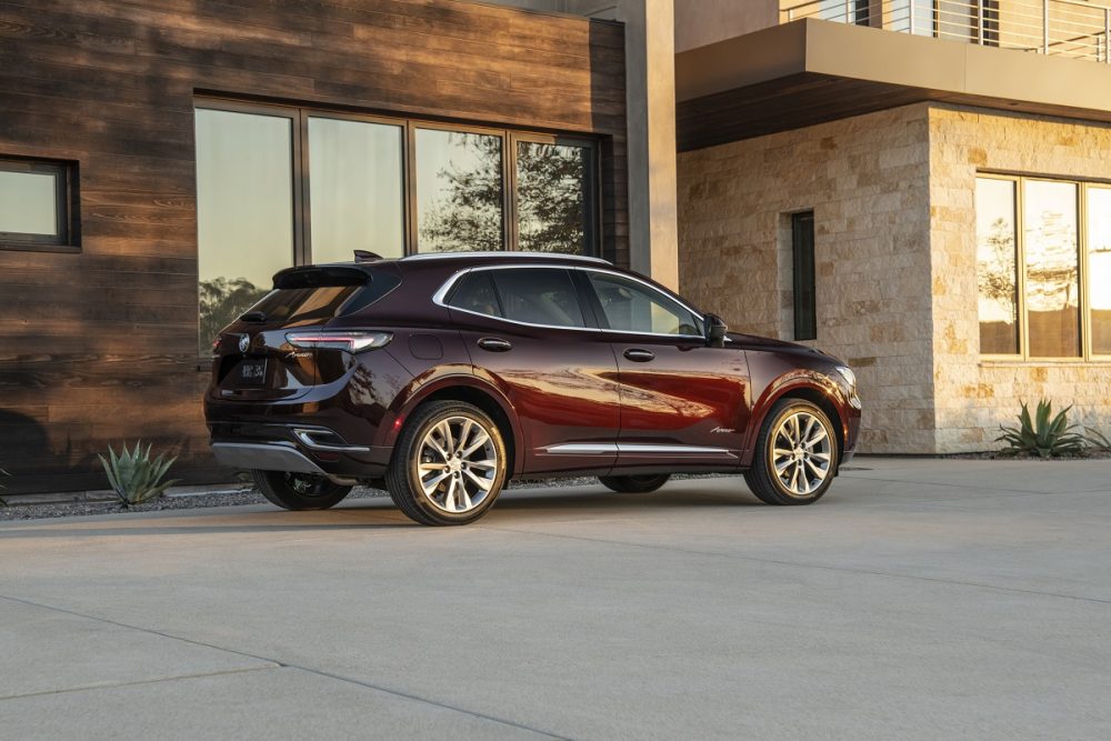 A side view of a 2021 Buick Envision parked by a building