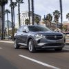 Front side view of 2021 Buick Envision driving down city street