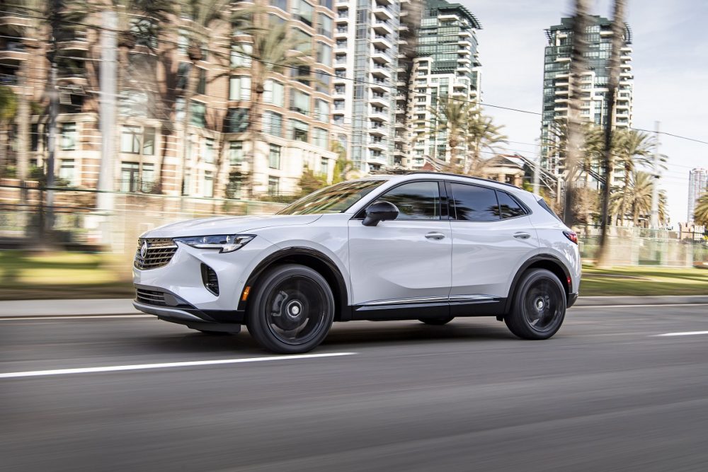 A side view of the 2021 Buick Envision driving down a city street