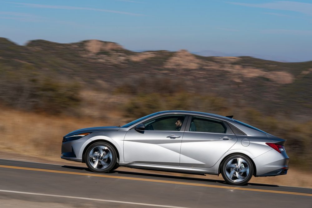 Side view of silver Hyundai Elantra driving on mountain road