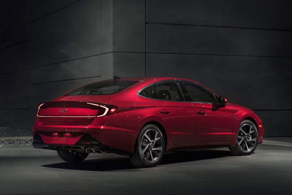 Rear side view of parked red Hyundai Sonata