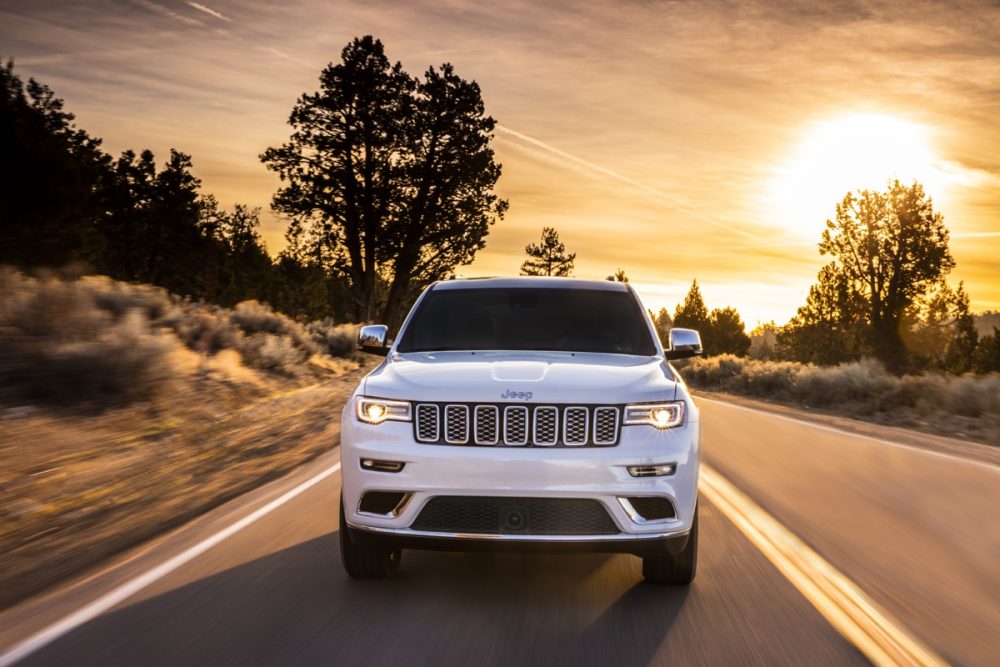 The front of the 2021 Jeep Grand Cherokee Summit as it drives down the road