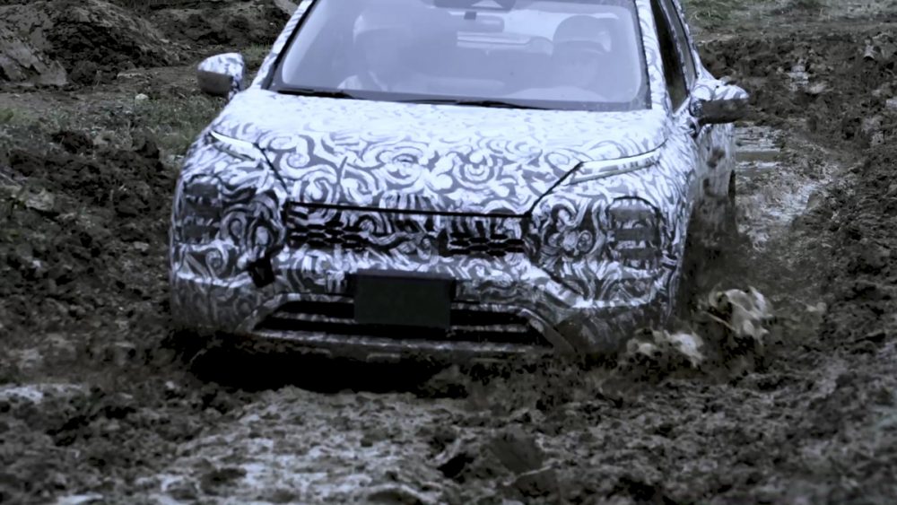 The 2022 Outlander driving in the mud