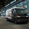 BrightDrop EV600 electric delivery van driving down street at night