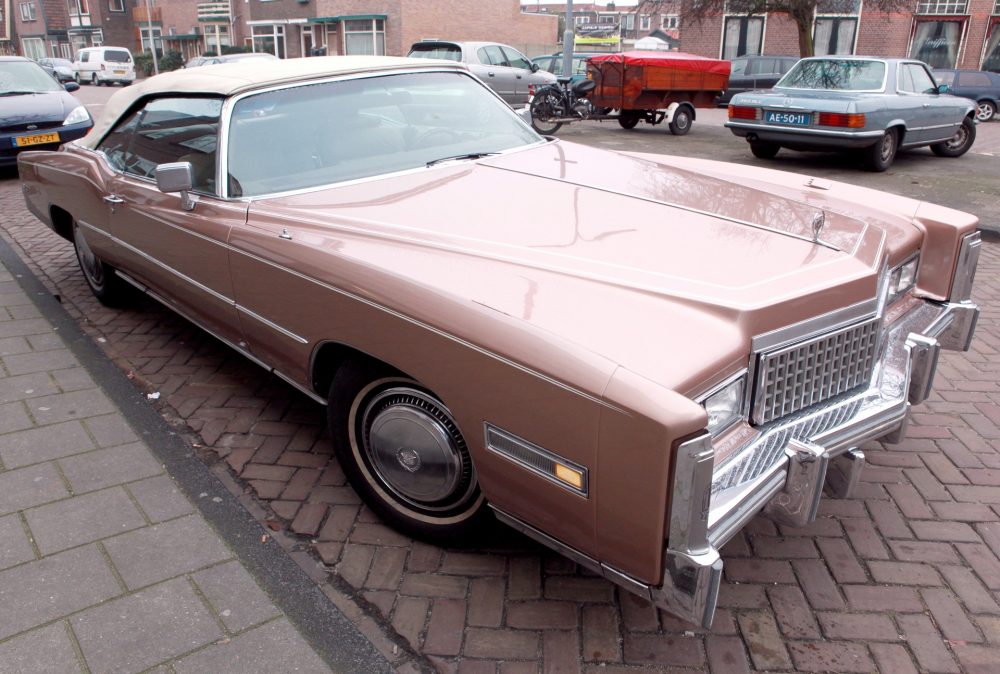 A soft pink Cadillac Eldorado convertible with the top up, much like the one featured in The Nice Guys