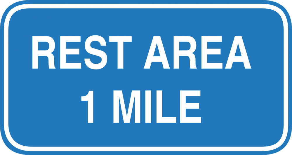 A sign that says the next rest area is one mile away