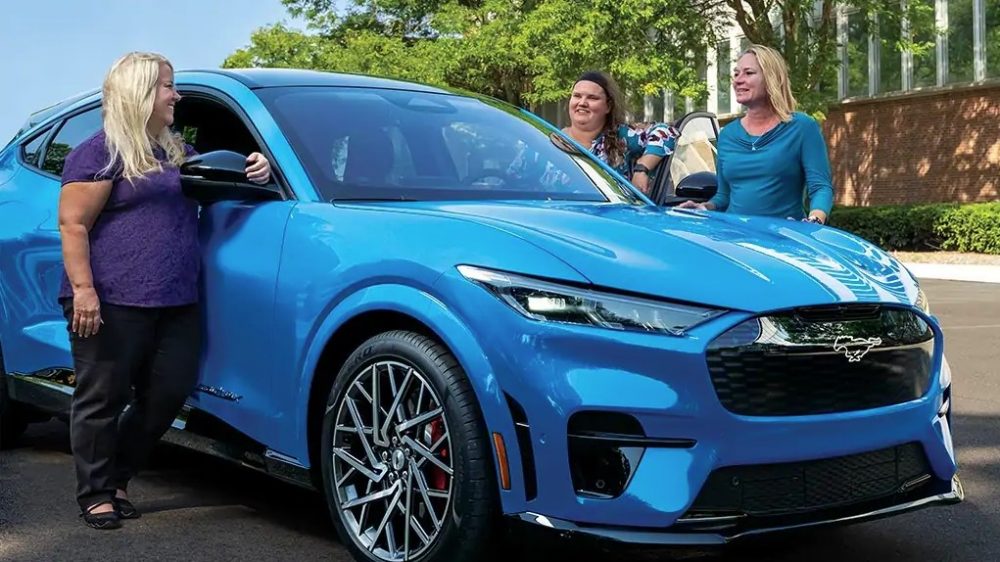 Three women, one of whom is Lori Cichewicz, check out the 2021 Ford Mustang Mach-E 