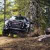 Head-on view of 2021 GMC Sierra 1500 AT4 off-roading in woods