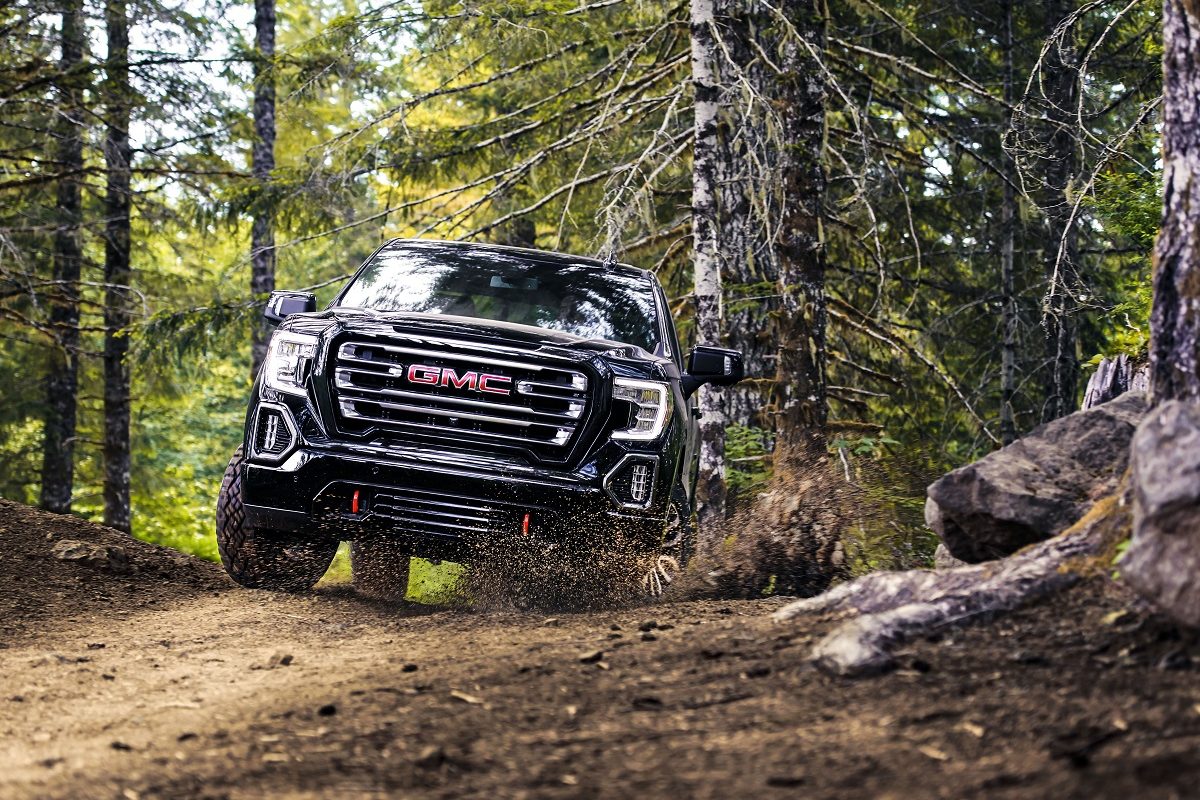 Head-on view of 2021 GMC Sierra 1500 AT4 off-roading in woods