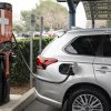 The 2021 Mitsubishi Outlander PHEV charging at a station