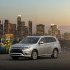 The 2021 Mitsubishi Outlander PHEV in front of a city