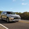 The 2021 Mitsubishi Outlander PHEV driving on the street