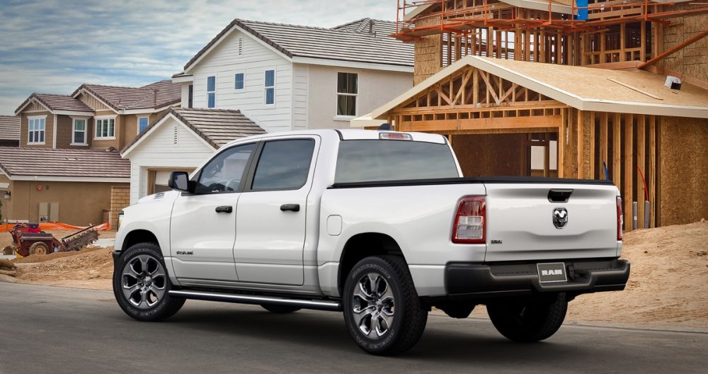 The 2021 Ram 1500 Tradesman HFE EcoDiesel in front of an unfinished house