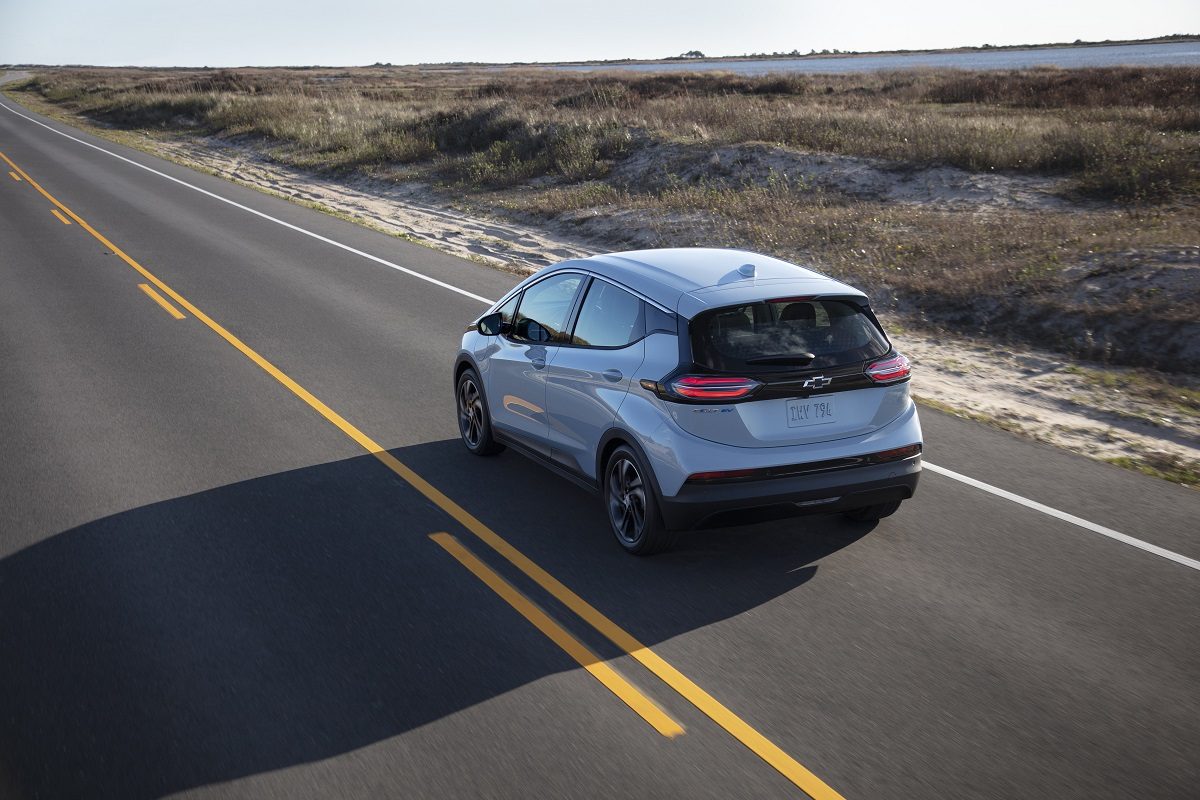 Rear overhead view of 2022 Chevrolet Bolt EV driving down road