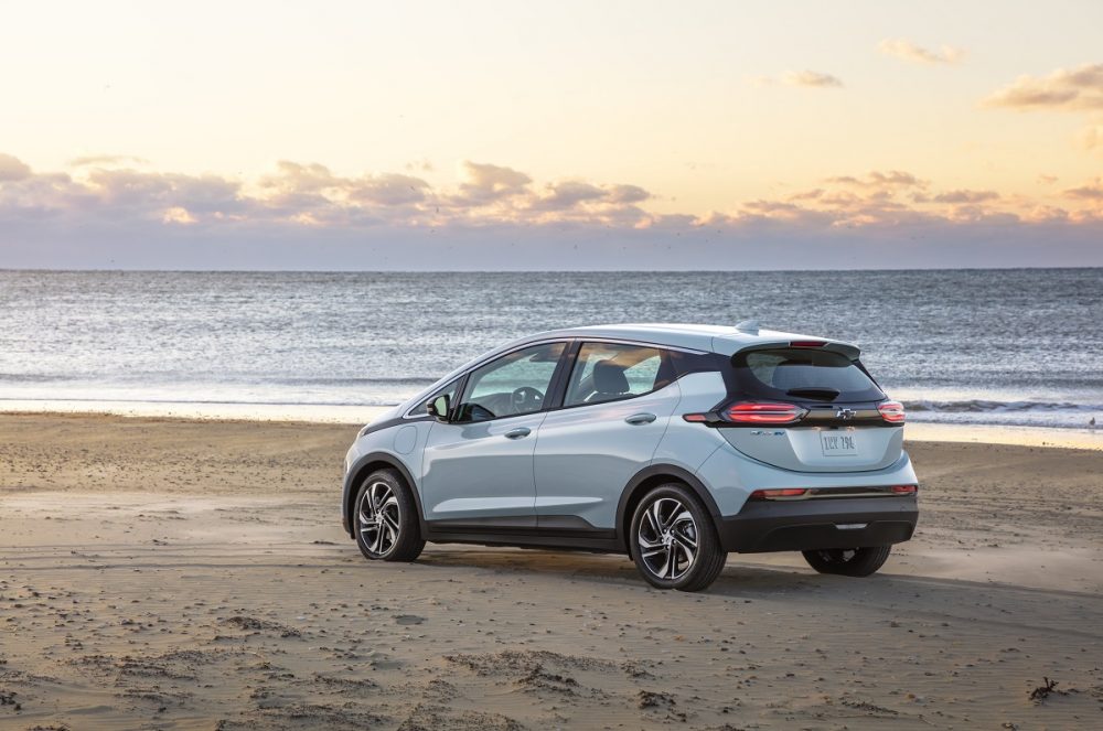 Rear side view of 2022 Chevrolet Bolt EV parked on beach