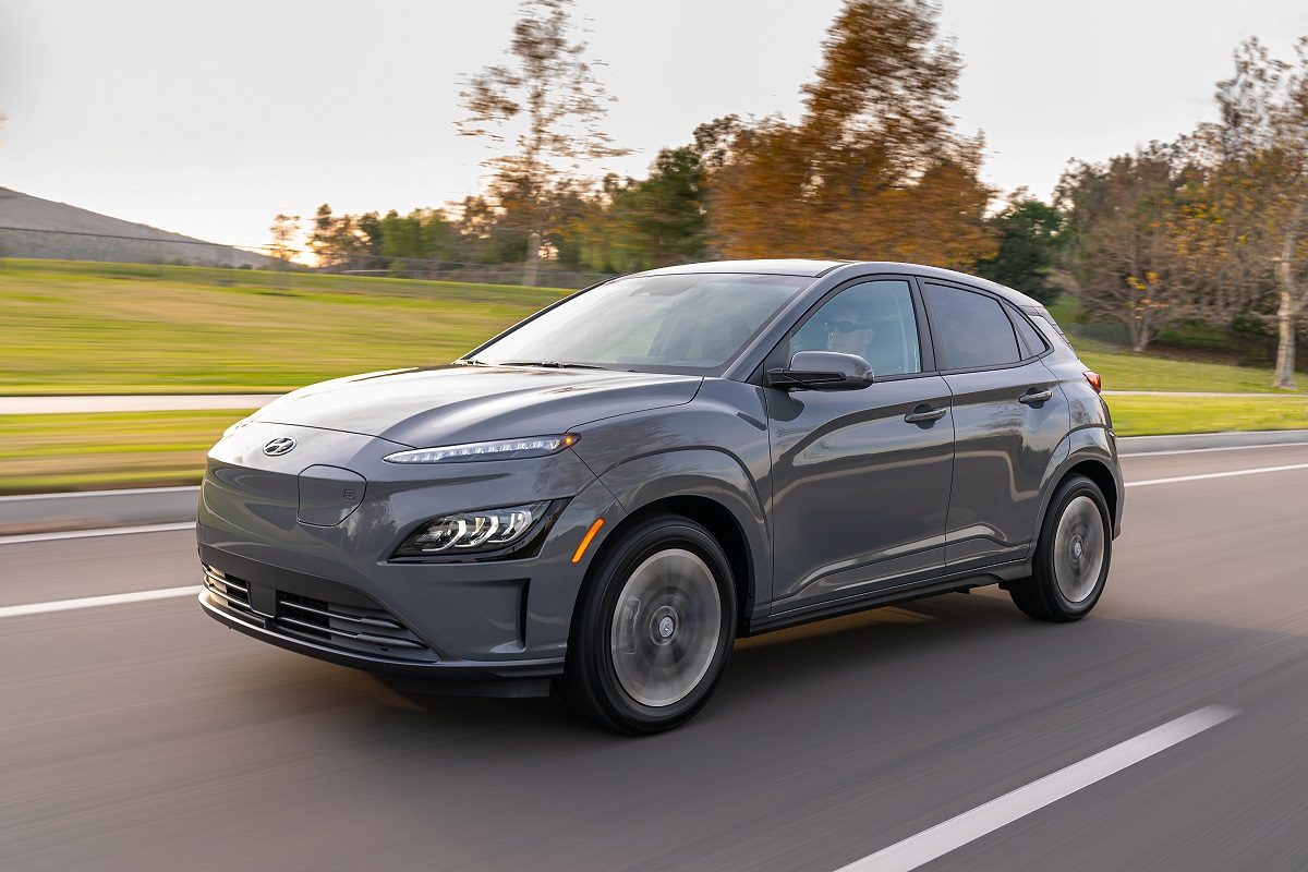 Front side view of 2022 Hyundai Kona Electric driving down road