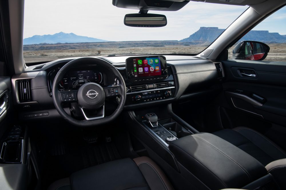 2022 Nissan Pathfinder interior front seats, with steering wheel and touch screen infotainment system shown