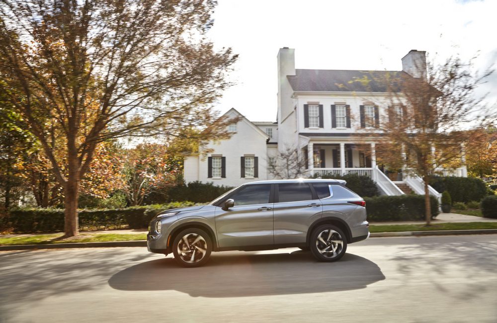 The 2022 Mitsubishi Outlander in front of a house