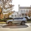 The 2022 Mitsubishi Outlander in front of a house
