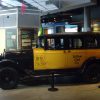 A 1930 Yellow Coach taxi on display in a museum, sitting in far better condition than the one you drive in Mafia.