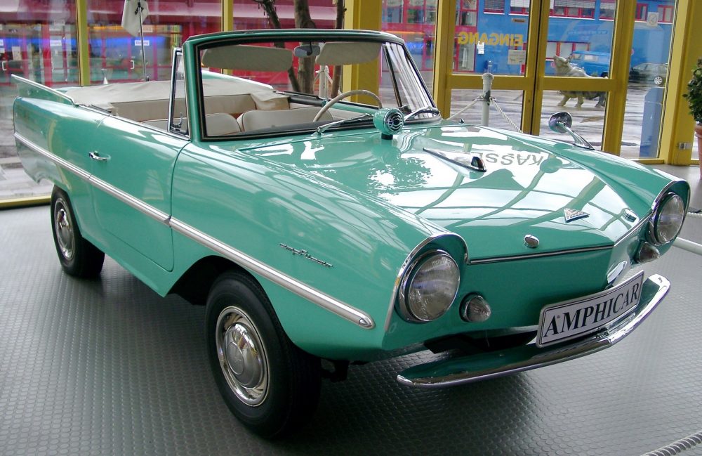 A front view of a teal Amphicar, the only mass-produced amphibious vehicle ever made