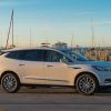 Side view of Buick Enclave parked next to harbor and boats