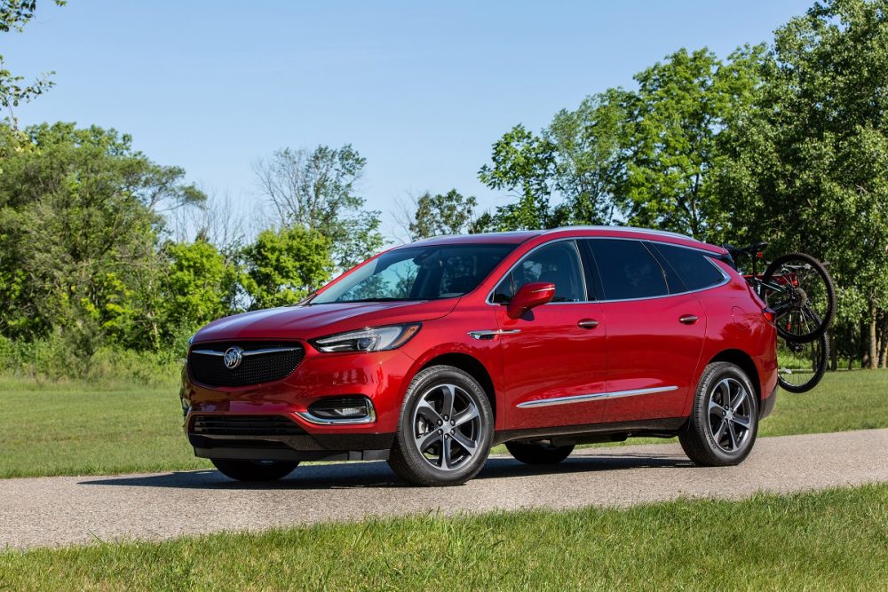 The Buick Enclave Sport Touring parked in front of a grassy field
