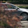 Partial side view of Cadillac XT5 through bushes