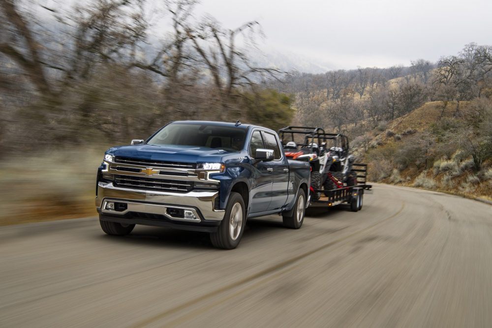 Front side view of Chevrolet Silverado 1500 towing a trailer