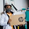 A student with the Girls in Engineering Academy poses with a laptop donated by Ford